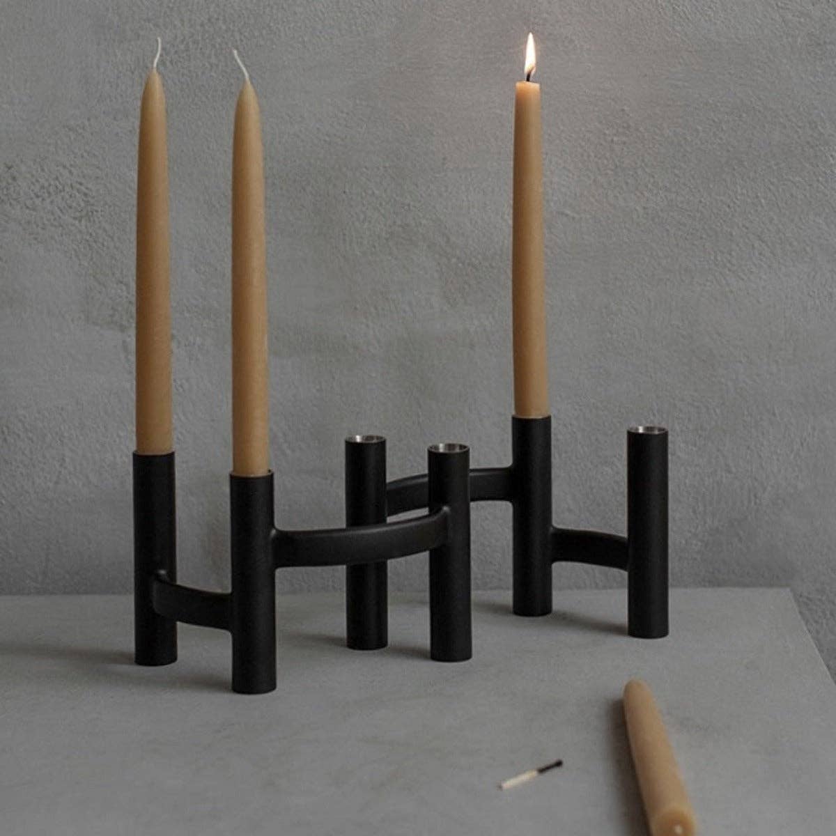 Stelton Ora Three-Branch Candleholder in black with organic sculptural design, holds three candles.