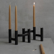 Stelton Ora Three-Branch Candleholder in black with organic sculptural design, holds three candles.