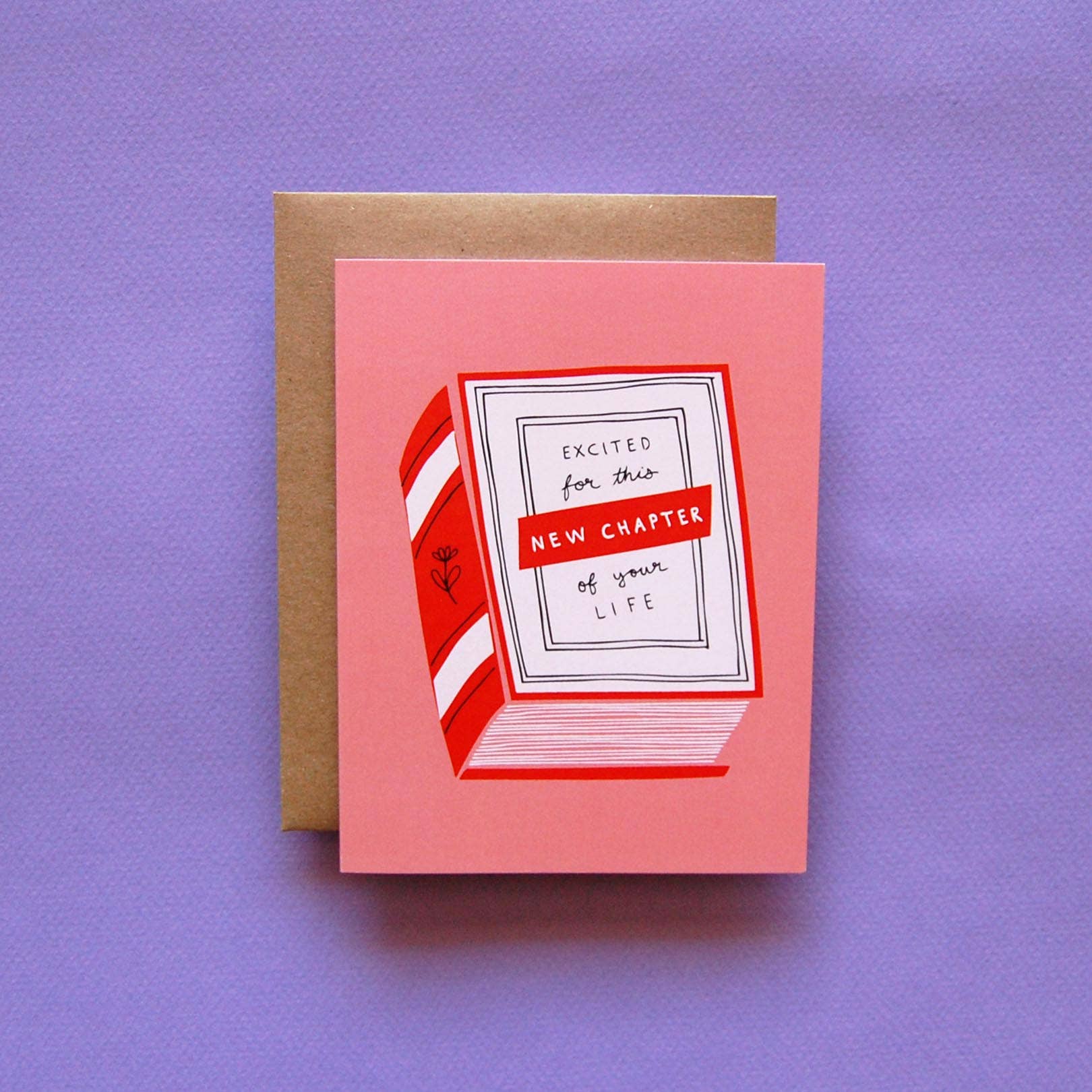 Badger & Burke New Chapter Card featuring an illustrated red and white striped book on a pink background with text reading “Excited for this new chapter of your life.”