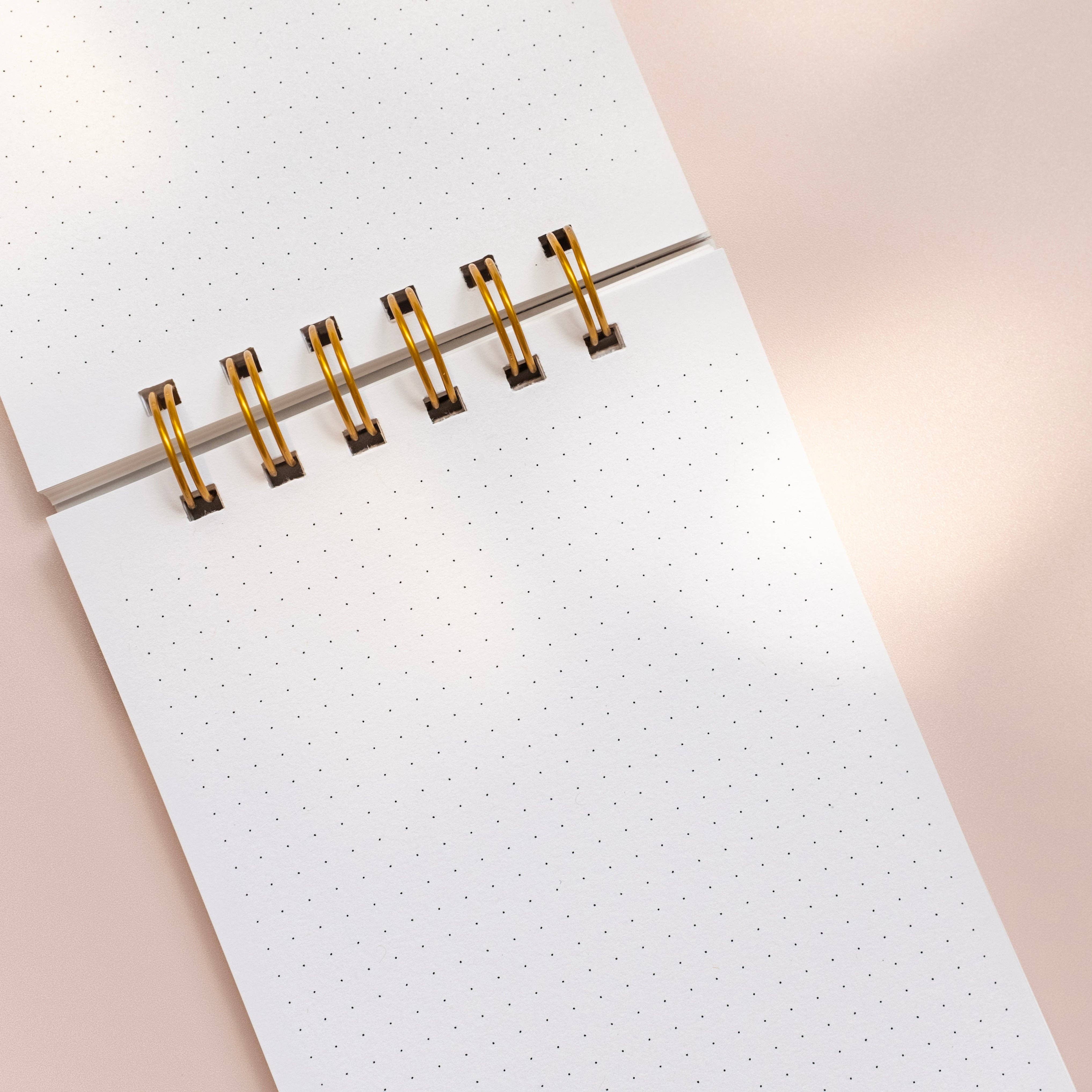 Worthwhile Paper Vibrance Geometry Dotted Jotter Notebook with colorful sunrise-inspired geometric design. Handmade wire-bound pocket notebook with cotton cover and recycled dotted paper, 4.25 × 5.5 inches.