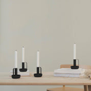 Ida Candle Holder in matte black powder-coated steel with handle and saucer base by Böttcher & Kayser.