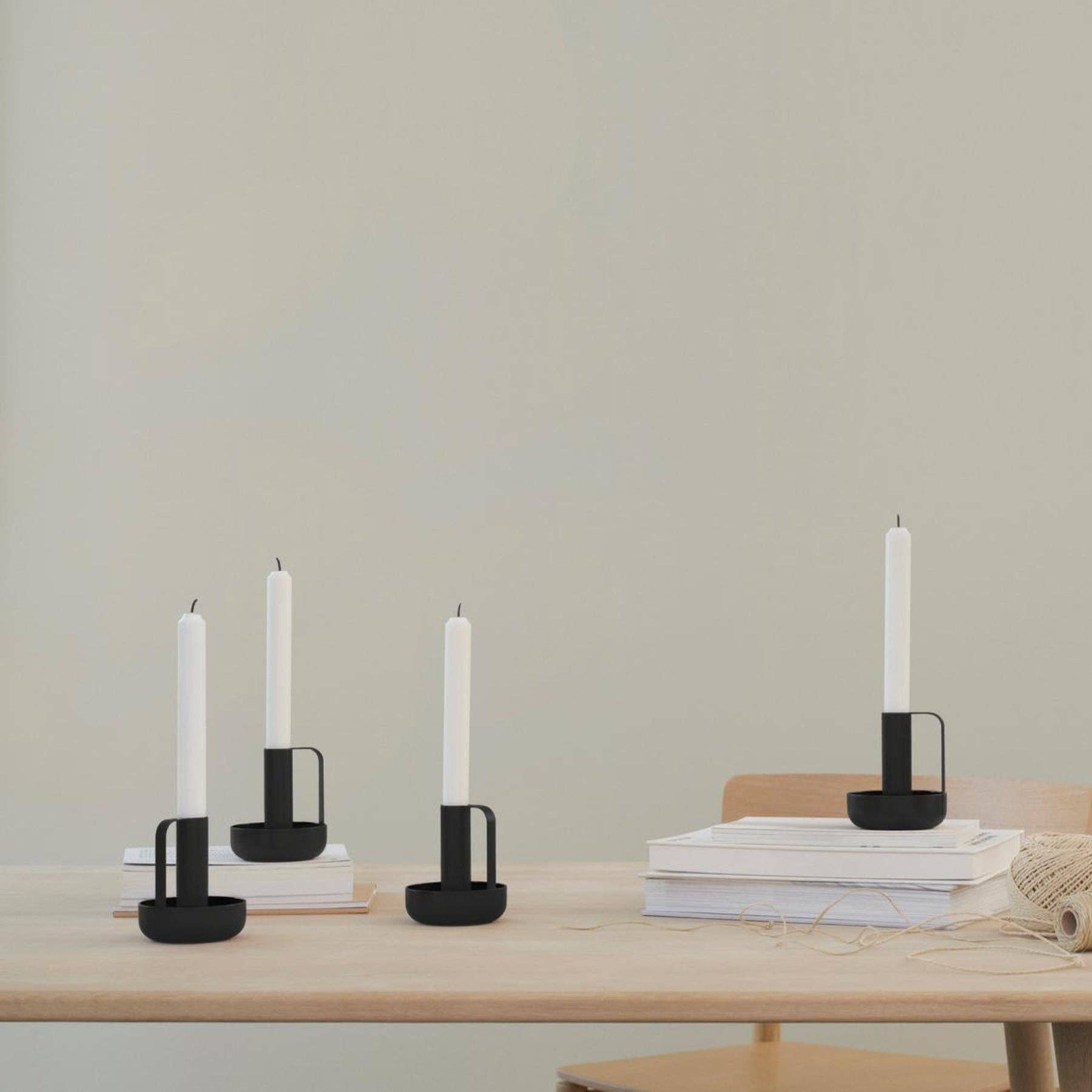 Ida Candle Holder in matte black powder-coated steel with handle and saucer base by Böttcher & Kayser.