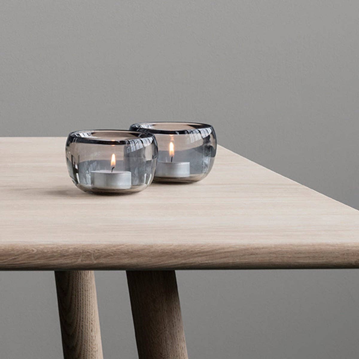 Stelton Ora Tealight Holders, set of 2 in translucent smoke glass with soft organic curves, modern Nordic design.