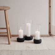 Stelton Hurricane Candle Holders in black or sand stoneware with glass shade, weather-resistant for indoor or outdoor candlelight.