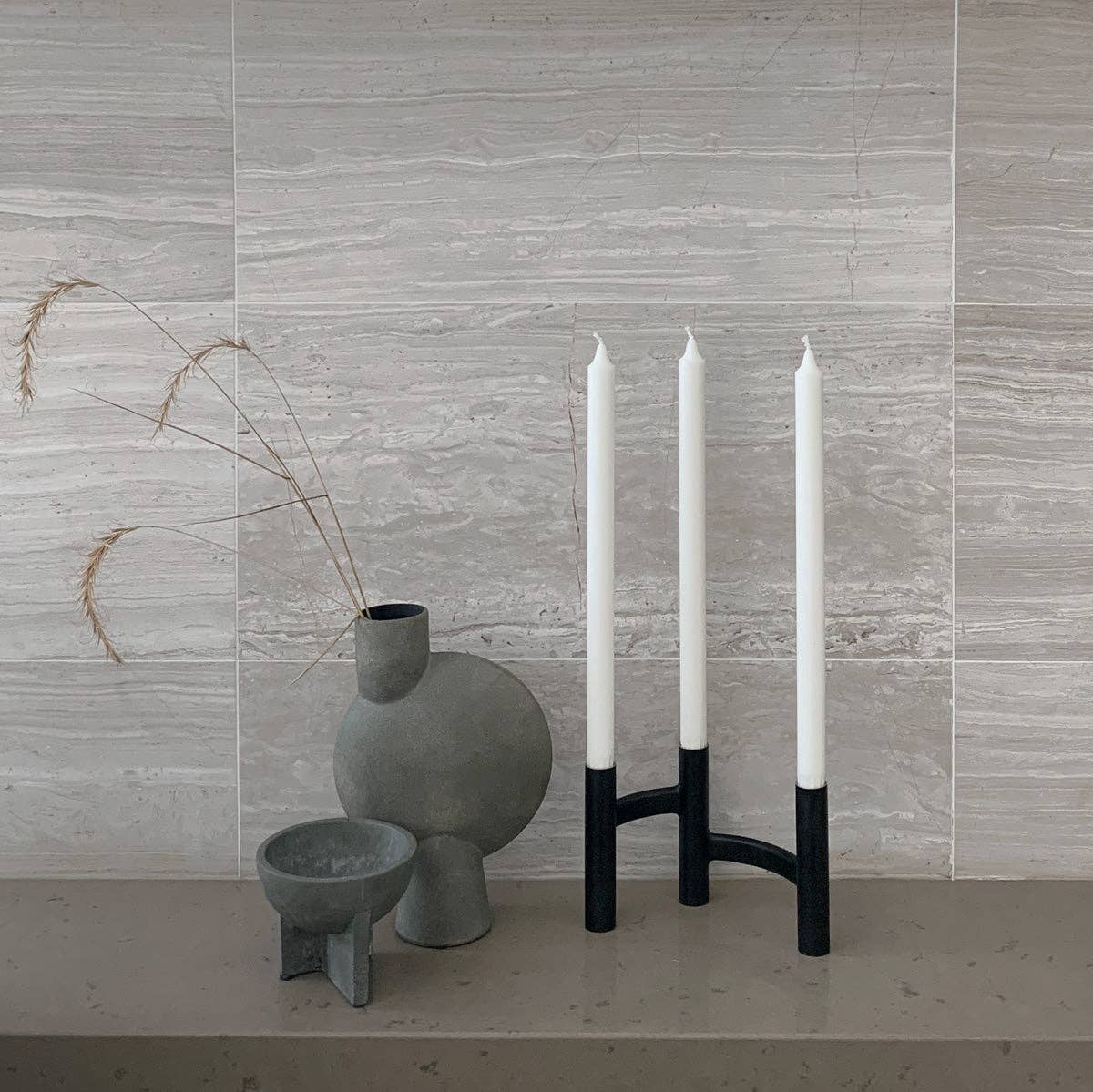 Stelton Ora Three-Branch Candleholder in black with organic sculptural design, holds three candles.