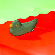 Colorful eco-friendly dog toy shaped like a bird, made from recycled PET bottles and Better Cotton™ fabric.