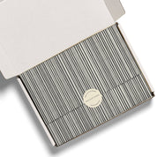 Red Cap Cards Black Stripe Tissue Paper, illustrated by Dylan Mierzwinski. Set of 5 black and white striped tissue sheets, 20 × 30 inches, 17 gsm.