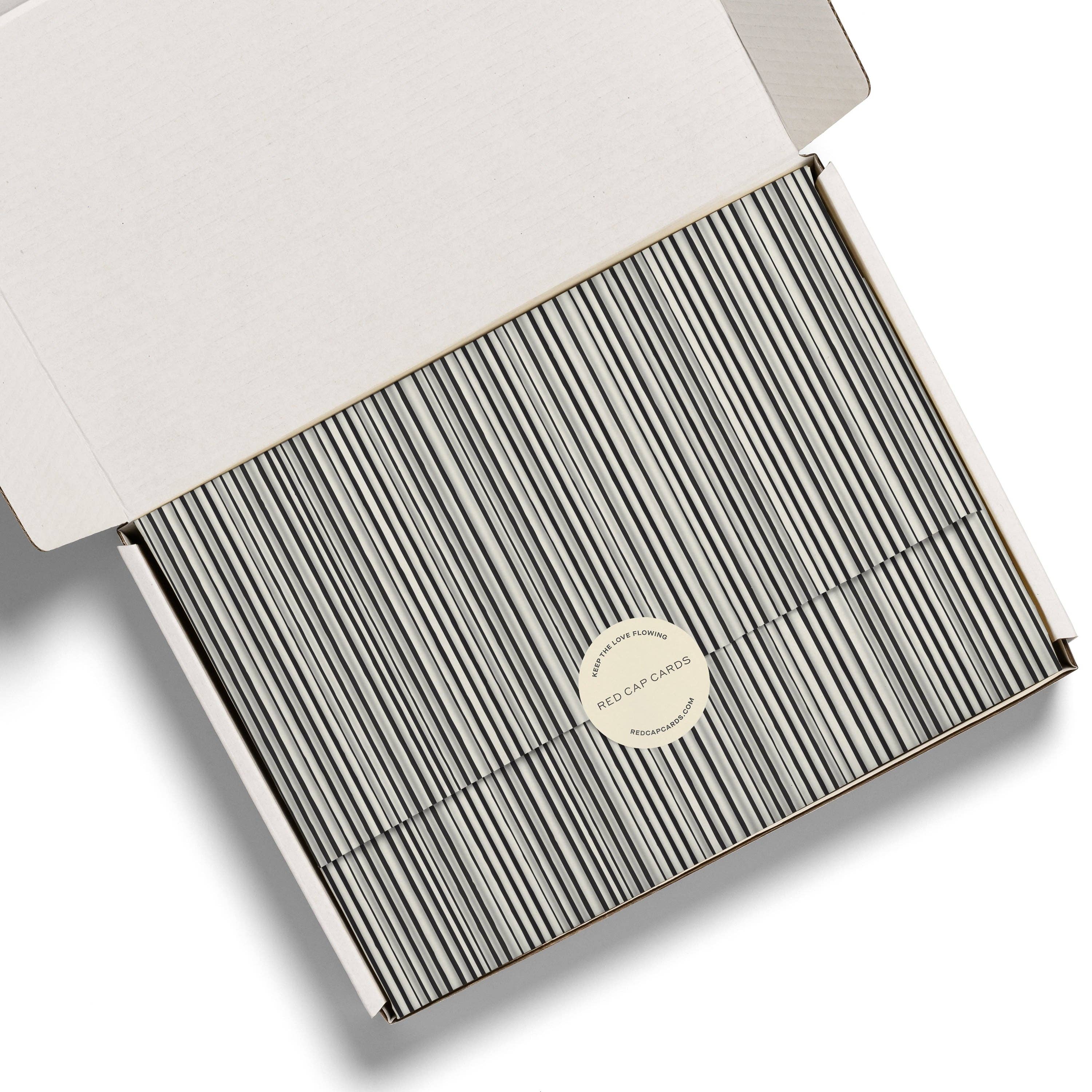 Red Cap Cards Black Stripe Tissue Paper, illustrated by Dylan Mierzwinski. Set of 5 black and white striped tissue sheets, 20 × 30 inches, 17 gsm.