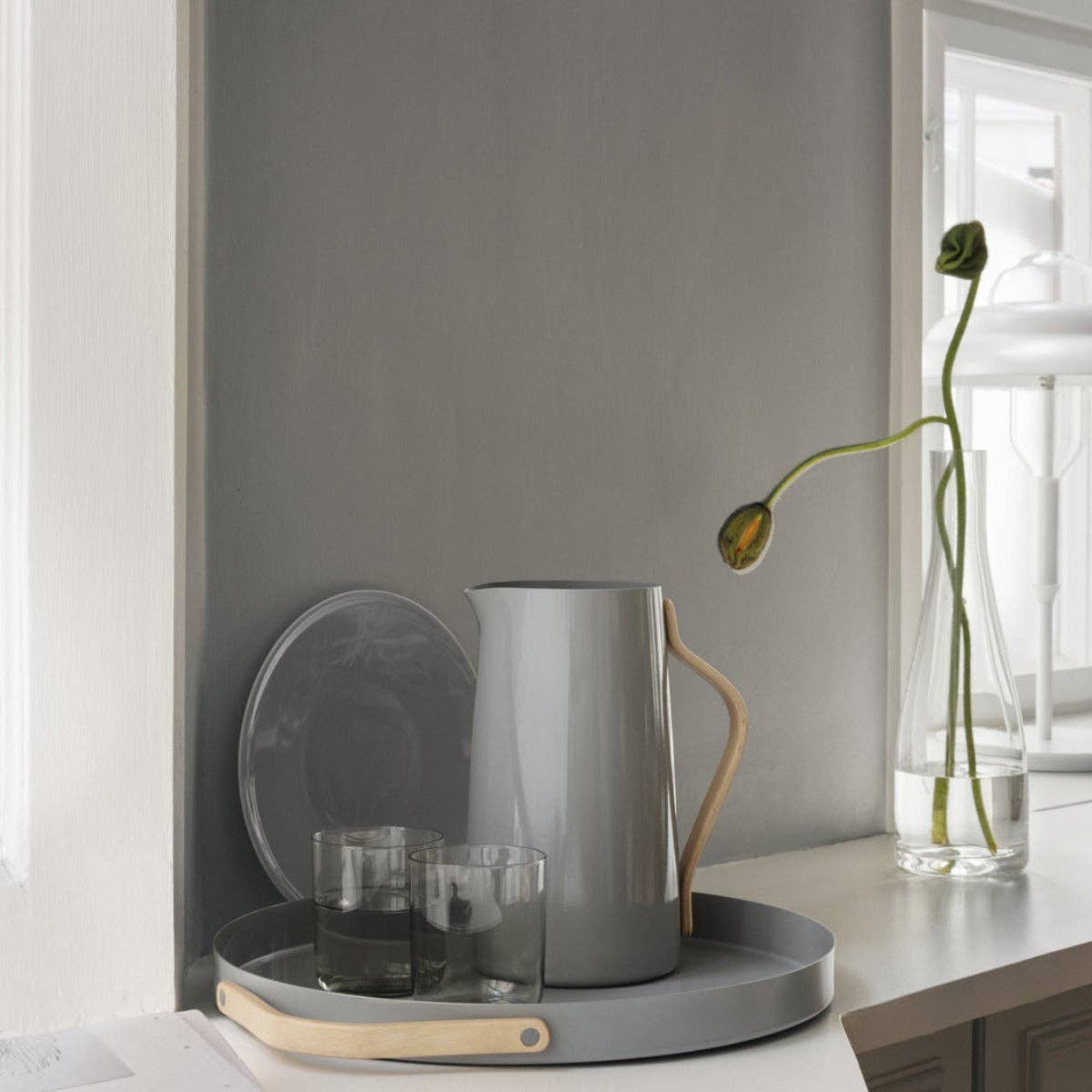 Stelton Emma Serving Tray and Pitcher in glossy light grey powder-coated steel with beechwood handles. Part of the Emma collection by HolmbäckNordentoft.