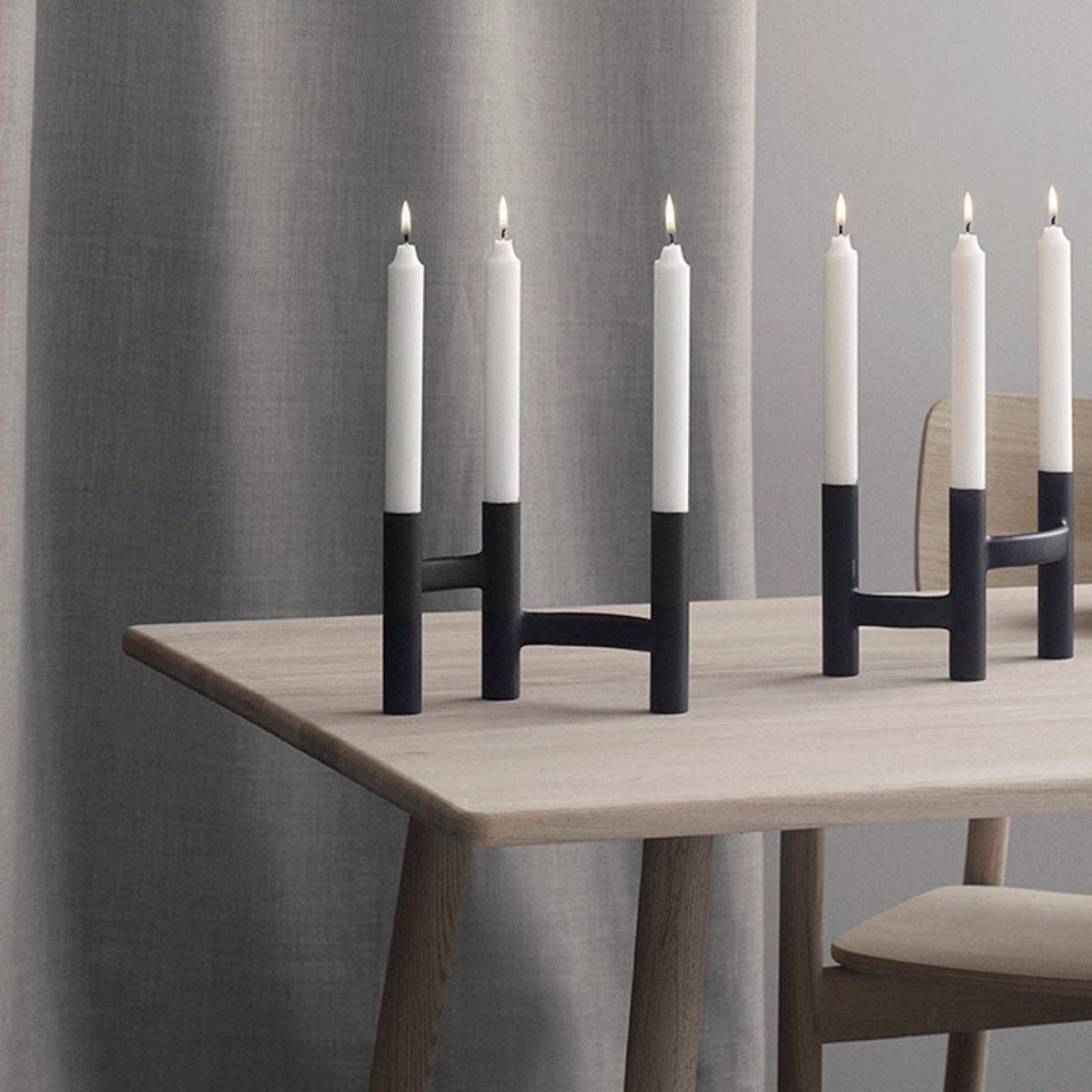 Stelton Ora Three-Branch Candleholder in black with organic sculptural design, holds three candles.