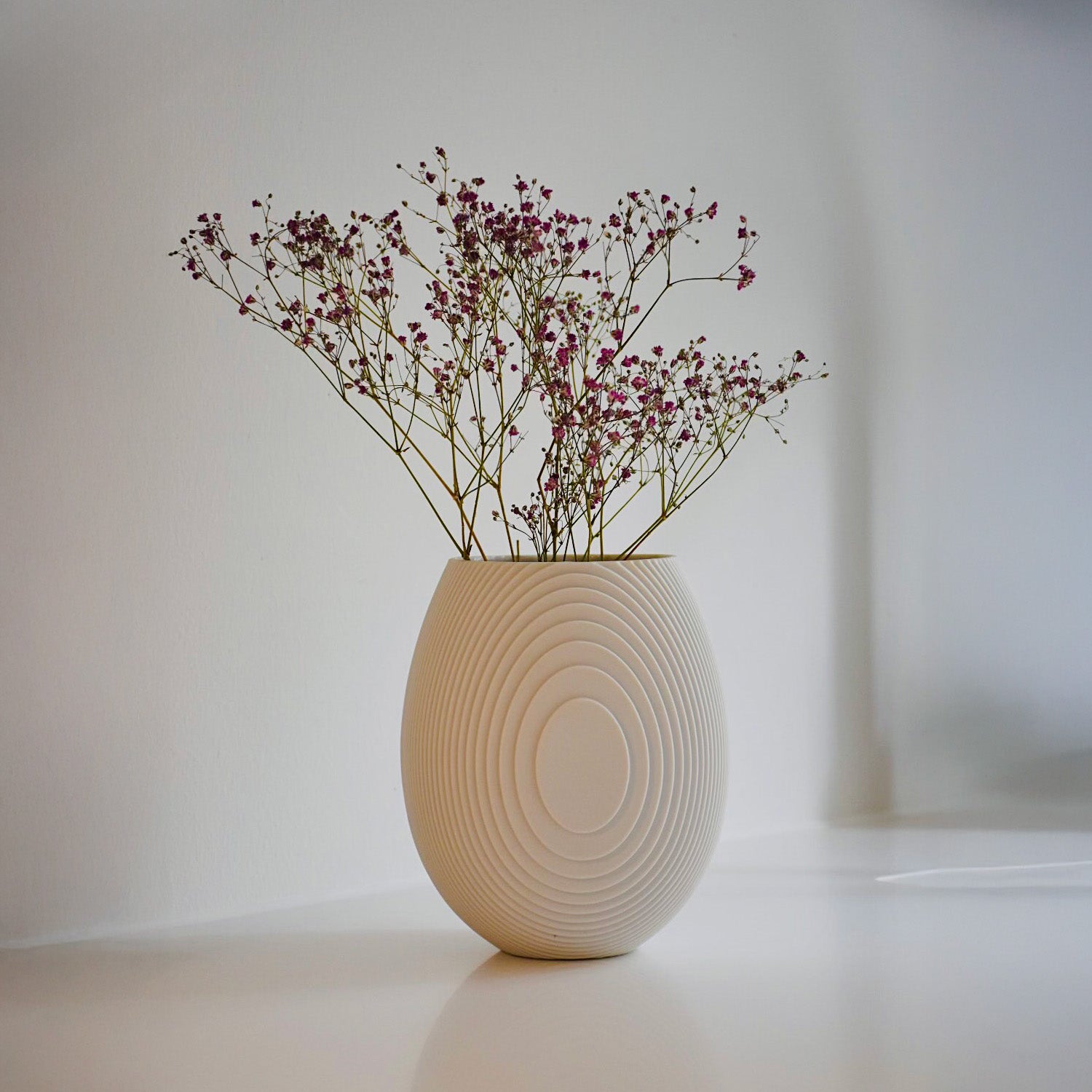 Architectmade Flow Vases in white porcelain, designed by Vibeke Rytter. Inspired by water ripples and Copenhagen’s Grundtvig’s Church.