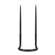 Architectmade Gemini Candleholder by Peter Karpf in matte black stainless steel, styled with matching black taper candles in a sculptural curved form.