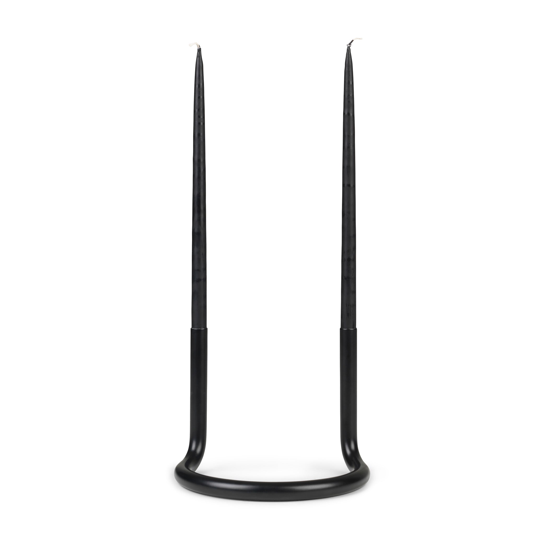Architectmade Gemini Candleholder by Peter Karpf in matte black stainless steel, styled with matching black taper candles in a sculptural curved form.