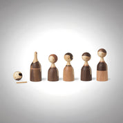 Architectmade Kin figurines by Lars Beller Fjetland, handmade in walnut, mahogany, and maple with tilting heads, shown in a mix-and-match constellation.