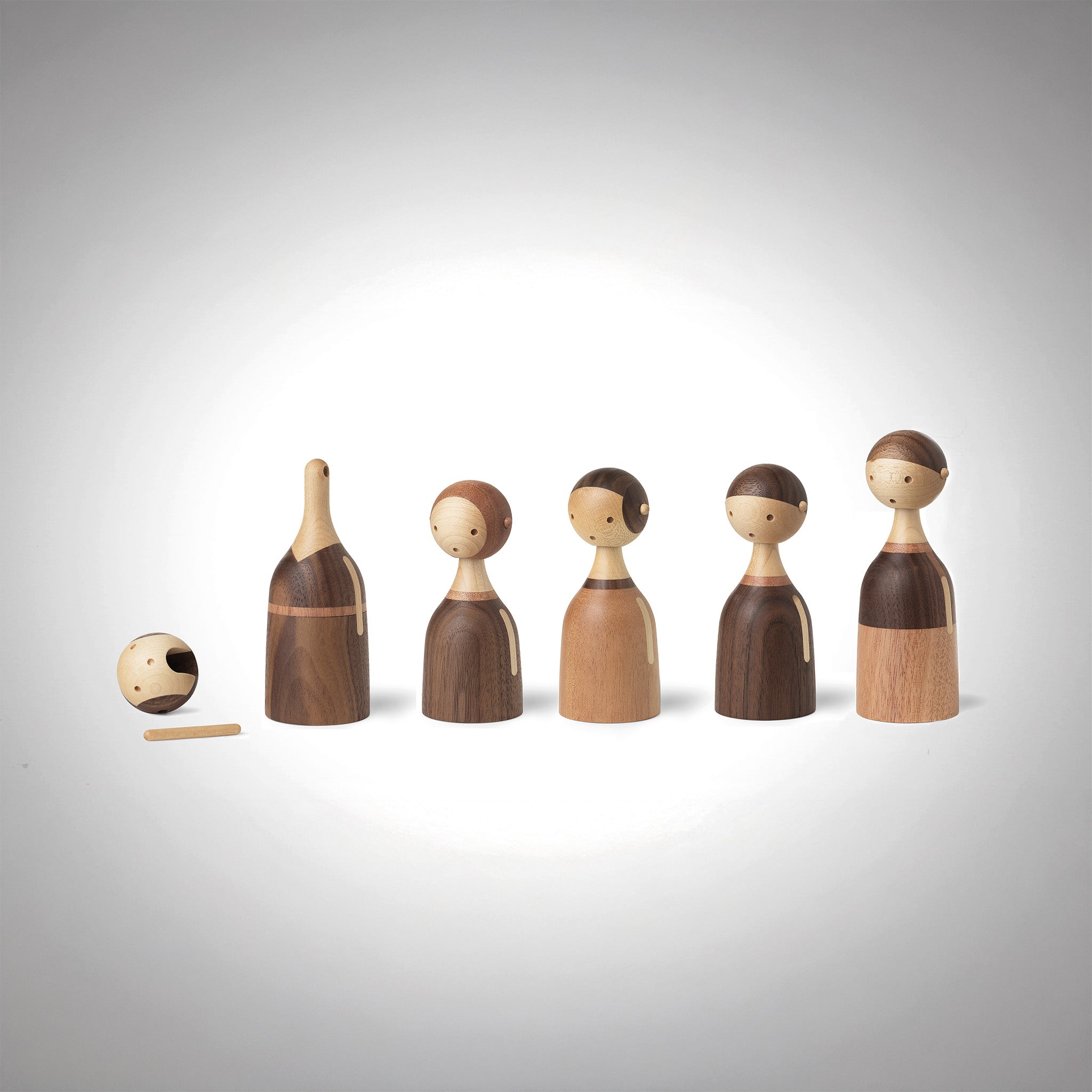 Architectmade Kin figurines by Lars Beller Fjetland, handmade in walnut, mahogany, and maple with tilting heads, shown in a mix-and-match constellation.