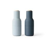 Audo Copenhagen Bottle Grinder in bottle-shaped form with beech lid. Minimal Nordic salt and pepper mill with inverted, mess-free design.