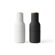 Audo Copenhagen Bottle Grinder in bottle-shaped form with beech lid. Minimal Nordic salt and pepper mill with inverted, mess-free design.