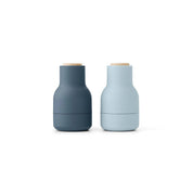Audo Copenhagen Small Bottle Grinder in bottle-shaped form with beech lid. Compact Nordic salt and pepper mill with inverted, mess-free design.