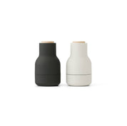 Audo Copenhagen Small Bottle Grinder in bottle-shaped form with beech lid. Compact Nordic salt and pepper mill with inverted, mess-free design.