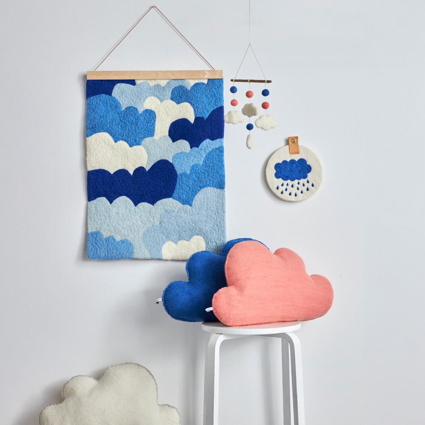 Aveva Design Cloud Cushion in blue or lilac, handmade from 100% wool in Nepal. Cloud-shaped pillow for kids’ rooms or cozy adult décor.