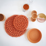 Aveva Design Round Wool Trivet, handmade wool circle design in multiple colors. Protects tables with playful style.