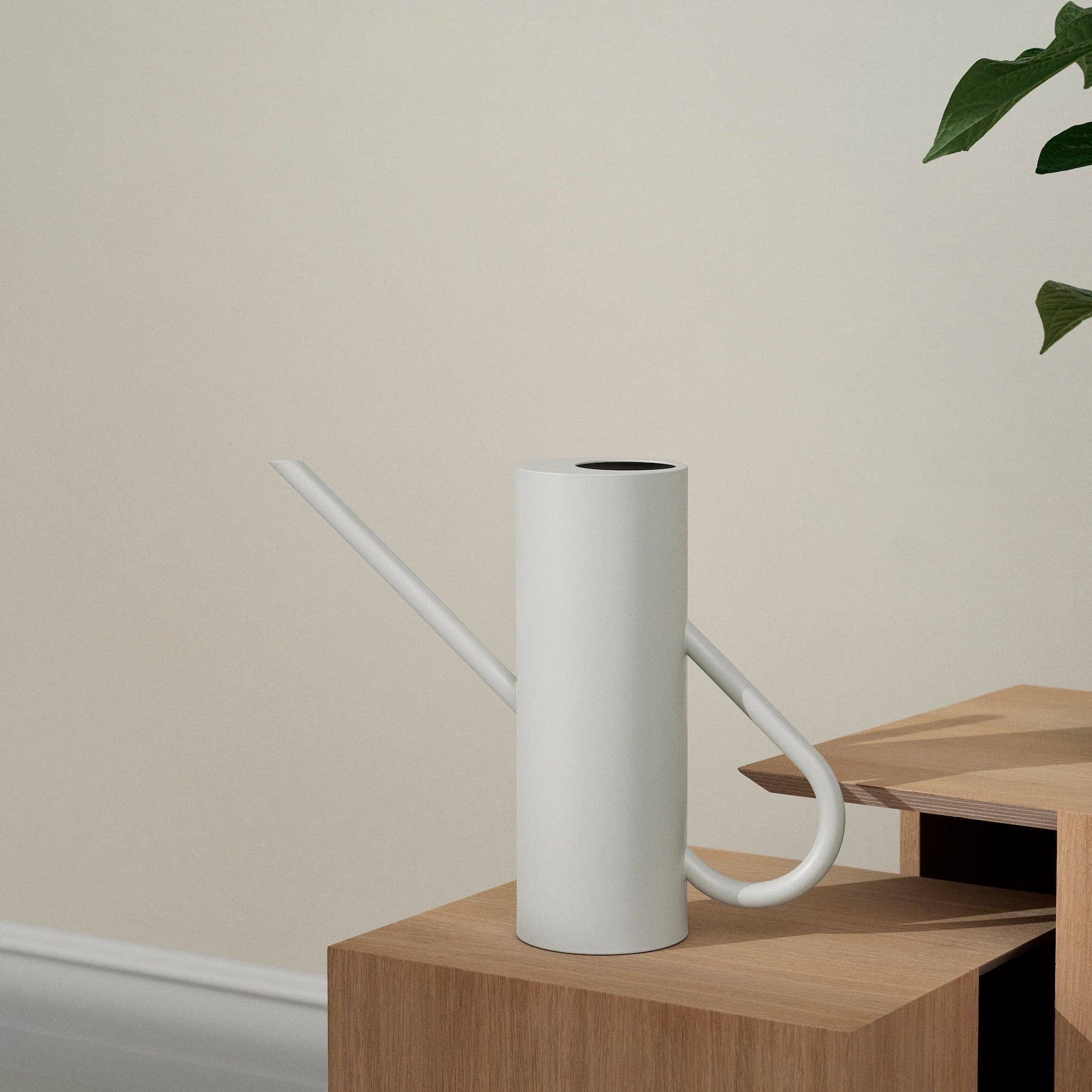 Stelton Bloom Watering Can in matte sand powder-coated stainless steel with long slender spout and seamless handle design.