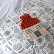 Donna Wilson House Hot Water Bottle with knitted lambswool cover, house-shaped design for cozy comfort.