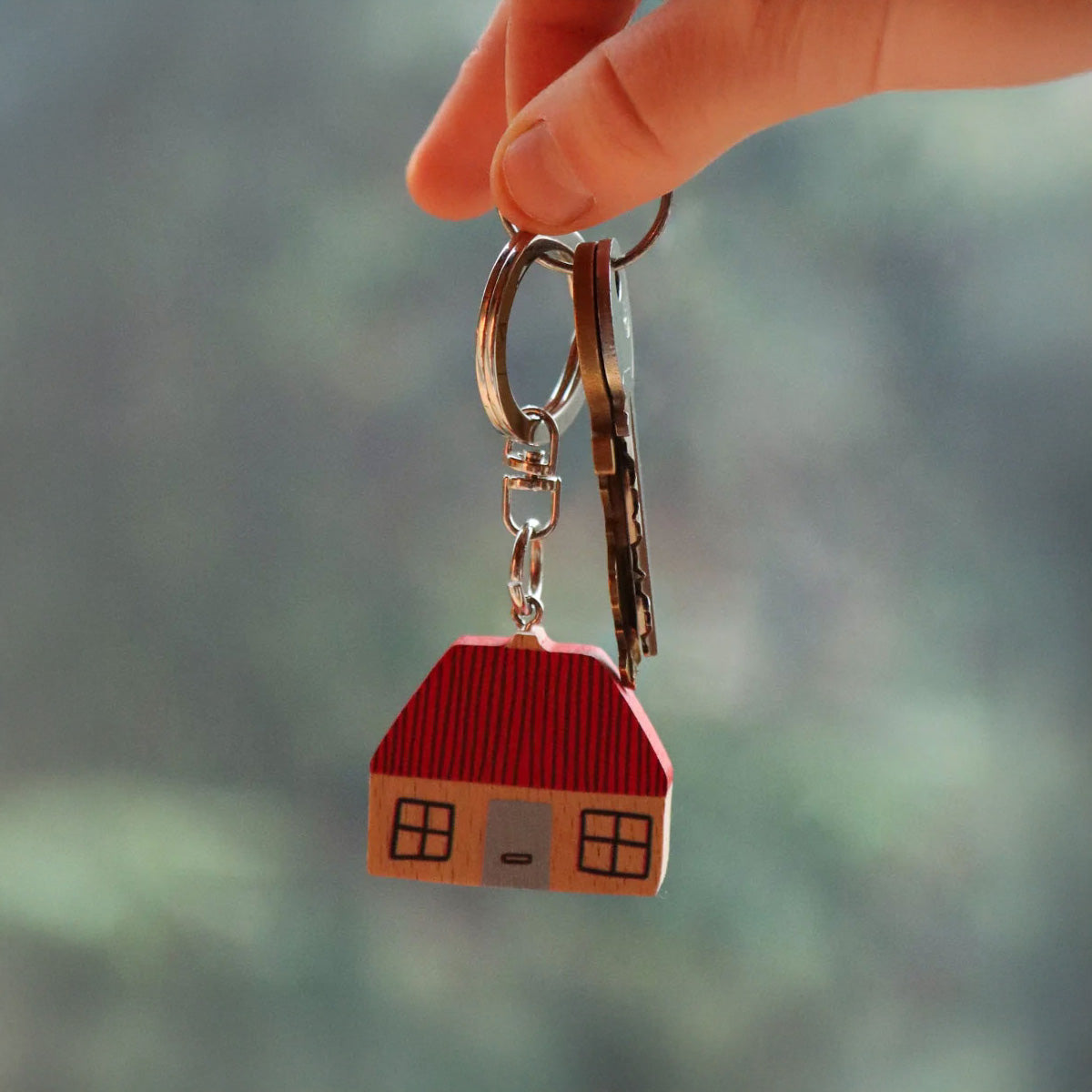 Donna Wilson House Keyring in FSC wood, house-shaped design with metal ring. Fun and durable key charm—pairs perfectly with the Leaf Keyring.