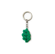 Donna Wilson Leaf Keyring in oak-leaf design, FSC wood charm with sturdy metal ring for keys or bags.