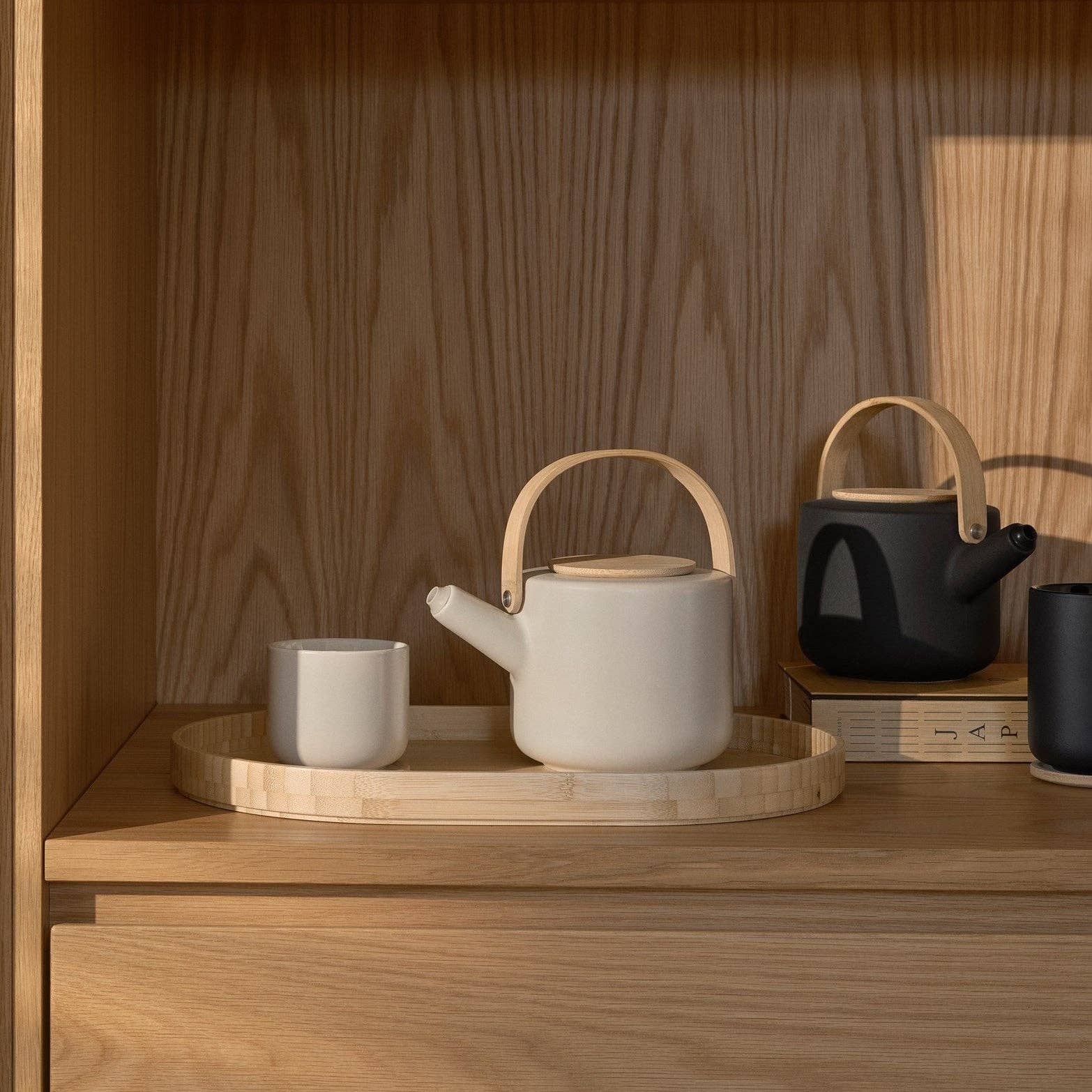 Stelton Theo Thermo Cup with bamboo coaster, available in matte black or sand stoneware with glossy interior, designed by Francis Cayouette. 0.25 L Nordic mug.