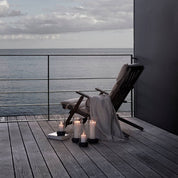 Stelton Hurricane Candle Holders in black or sand stoneware with glass shade, weather-resistant for indoor or outdoor candlelight.