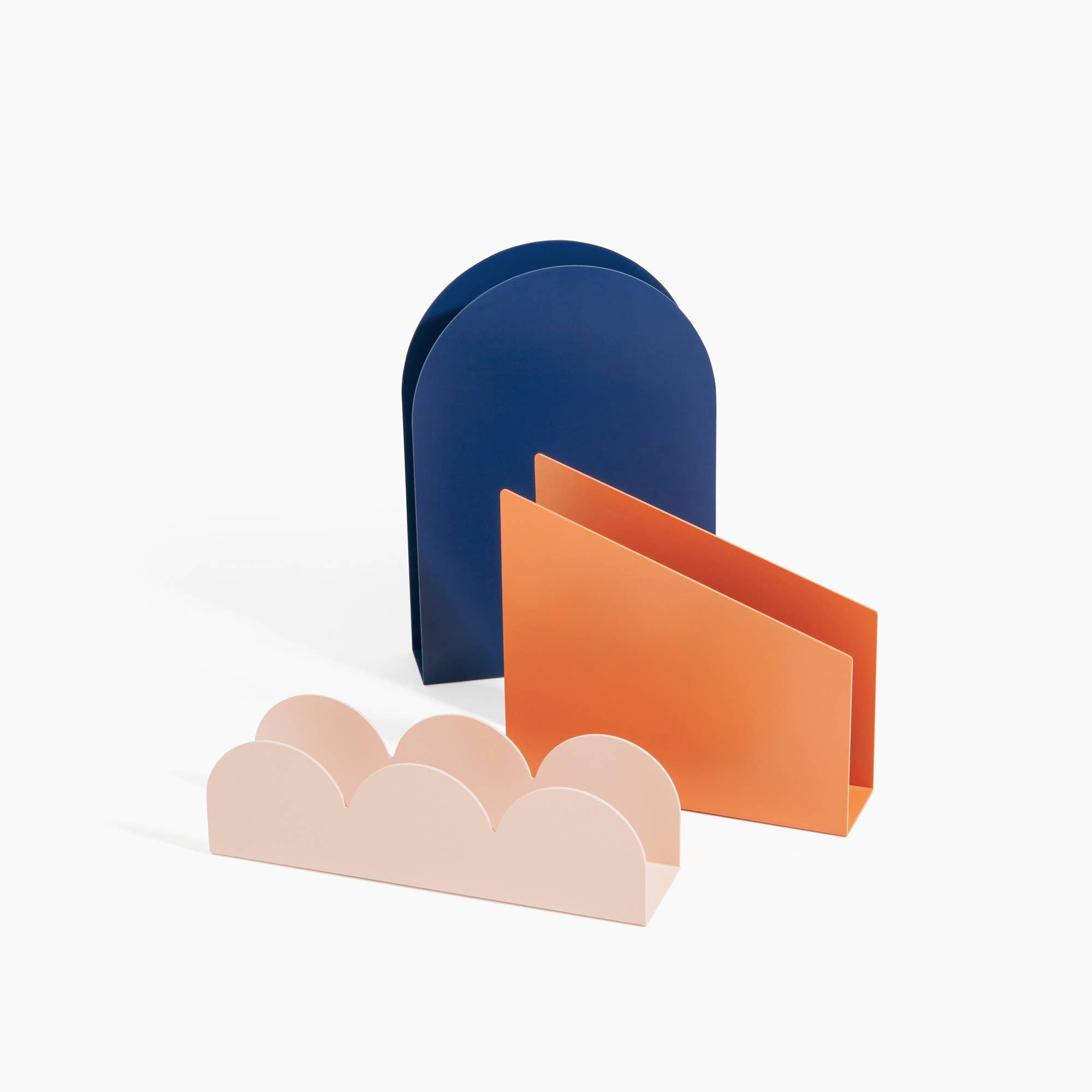 Poketo Forms Desk Organizer Set of 3 in blue dome, coral slant, and pink scallop shapes. Hand-painted metal organizers for stylish desks.