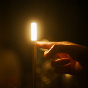 Graypants Wick Portable Rechargeable Candle Lamp in plated aluminum with warm white LED glow. Cordless, USB-C rechargeable, gift pack included.