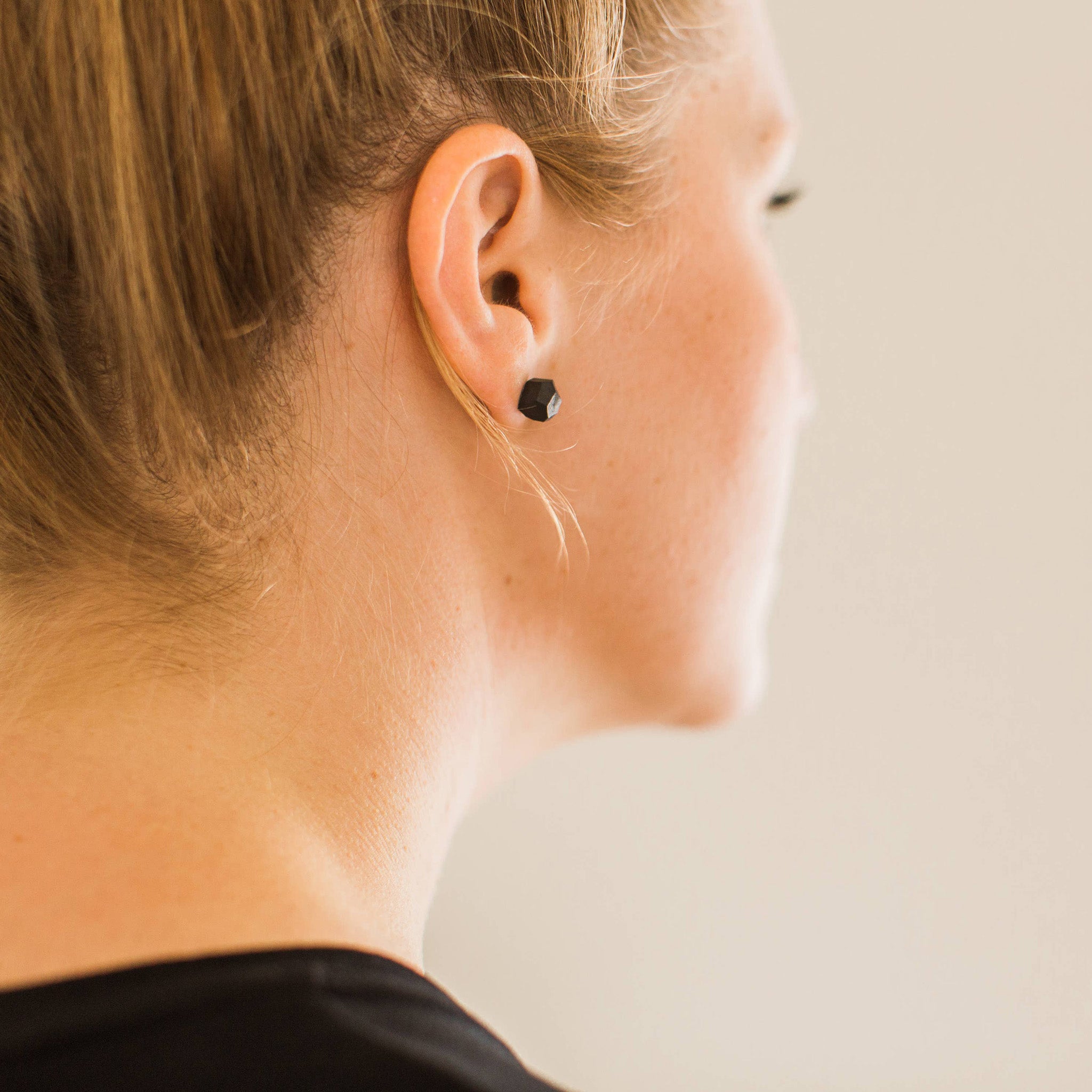 Black porcelain faceted stud earrings handmade by designer Jenna Vanden Brink, minimalist everyday studs with titanium backs