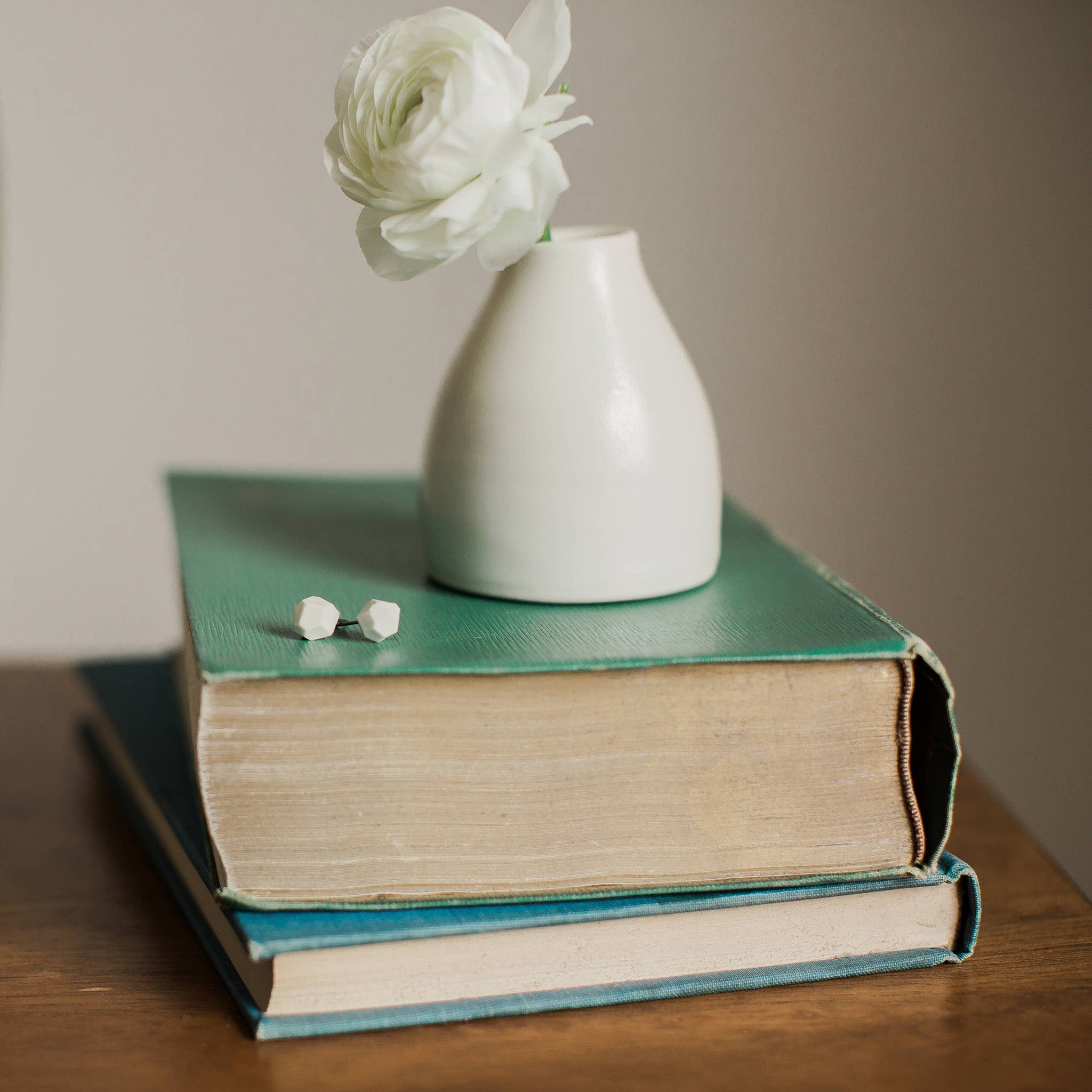 White porcelain faceted stud earrings handmade by designer Jenna Vanden Brink, minimalist everyday studs with titanium backs