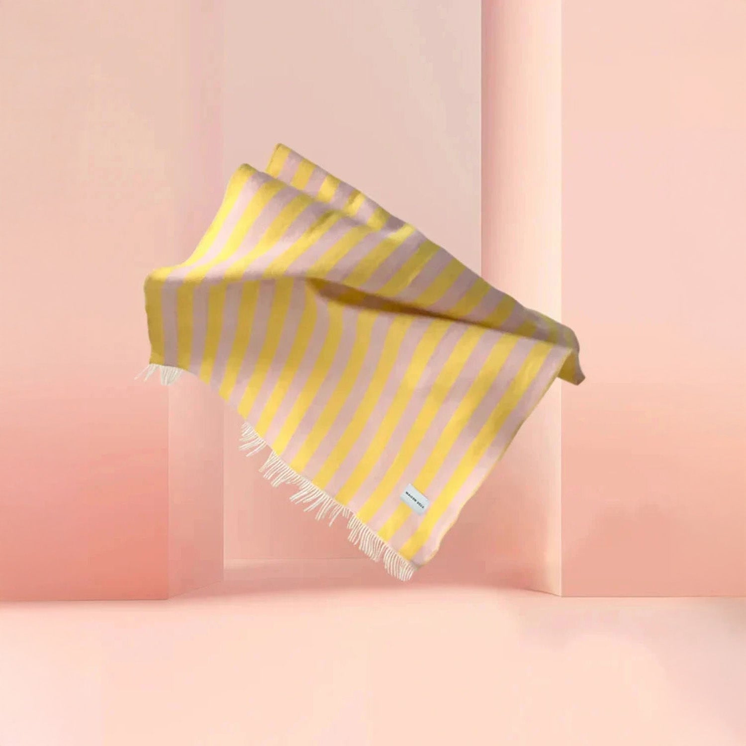 Maison Deux Candy Wrap Blanket in pink and yellow lambswool, reversible candy-stripe design, cozy modern throw.