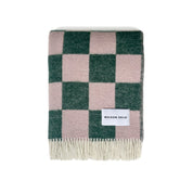 Maison Deux Checkerboard Blanket in green and pink lambswool with bold reversible checkerboard design.