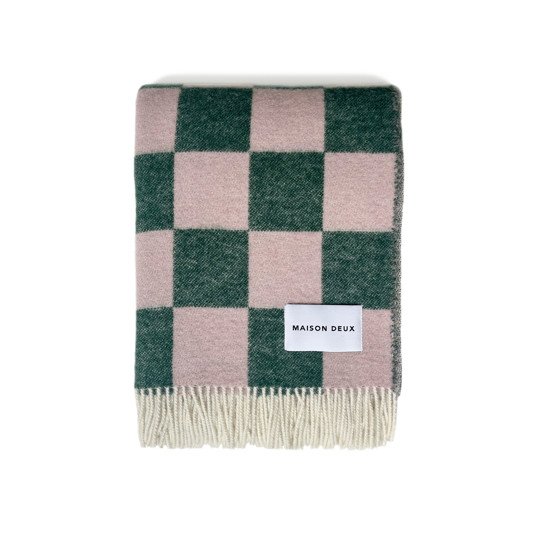 Maison Deux Checkerboard Blanket in green and pink lambswool with bold reversible checkerboard design.