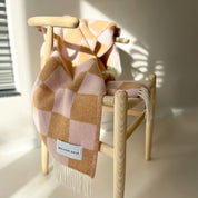Maison Deux Checkerboard Blanket in terra brown and pink lambswool with bold reversible checkerboard design.