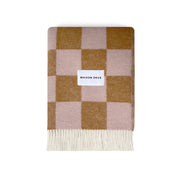 Maison Deux Checkerboard Blanket in terra brown and pink lambswool with bold reversible checkerboard design.