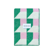 Maison Deux Cubics Blanket in grass and pink, reversible wool throw with cubic pattern and fringed edges, oversized for cozy lounging.