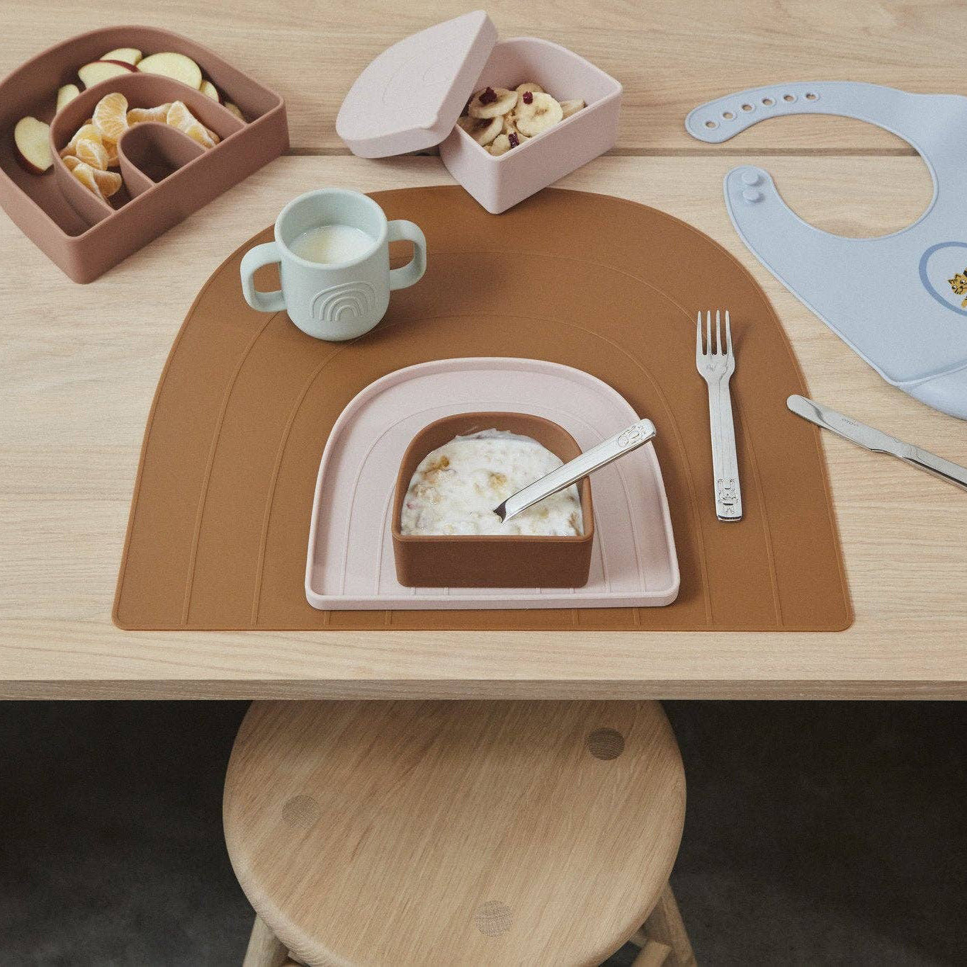 OYOY Rainbow Snack Bowl with Lid in dusty blue silicone, embossed rainbow design, dishwasher and microwave safe.