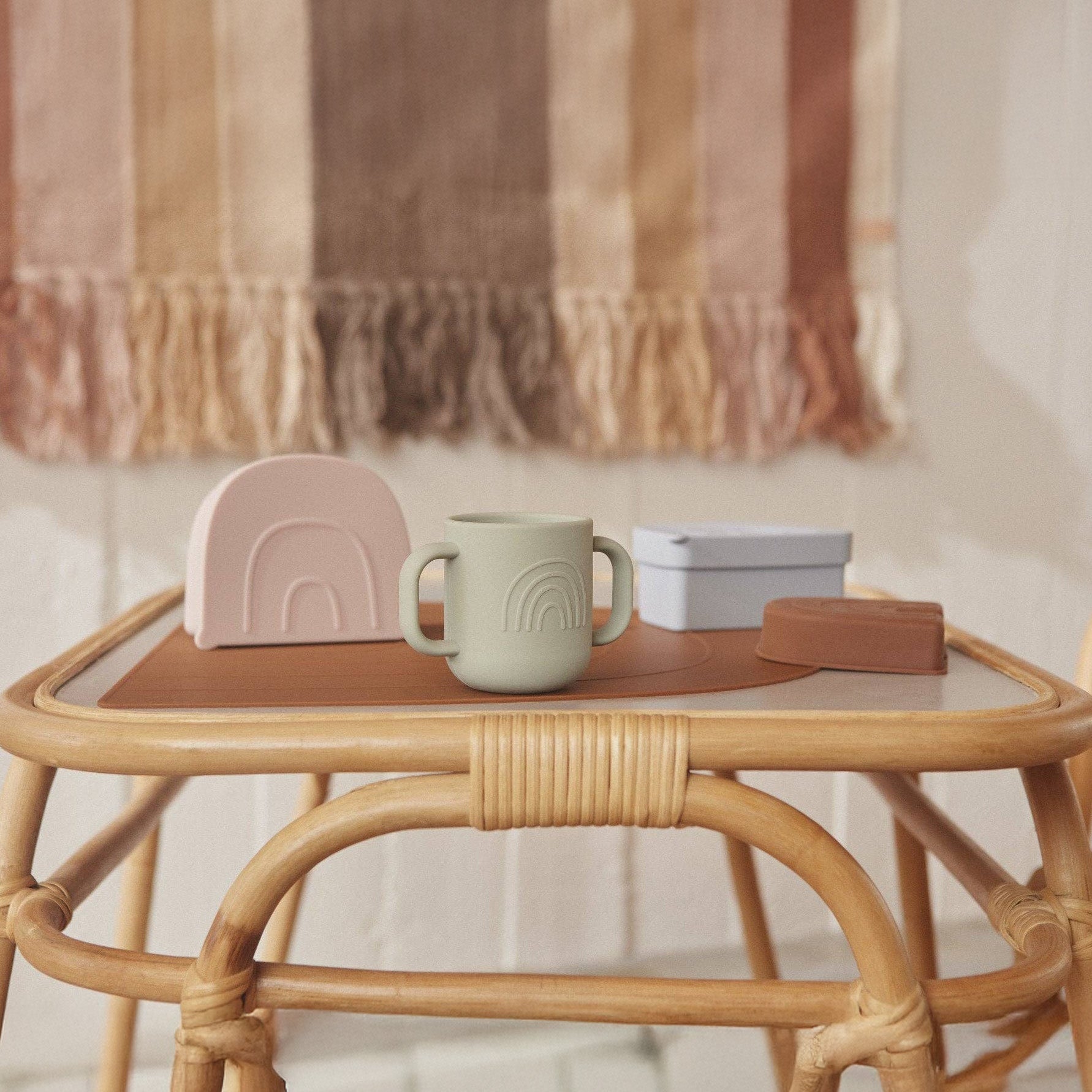 OYOY Kappu Cup set of 2 in clay and pale mint, two-handled silicone cups with embossed mushroom and rainbow designs.