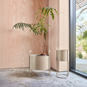 Maki Plant Box in Clay, Nutmeg, or Olive with rattan handles, shown in Low and High versions.