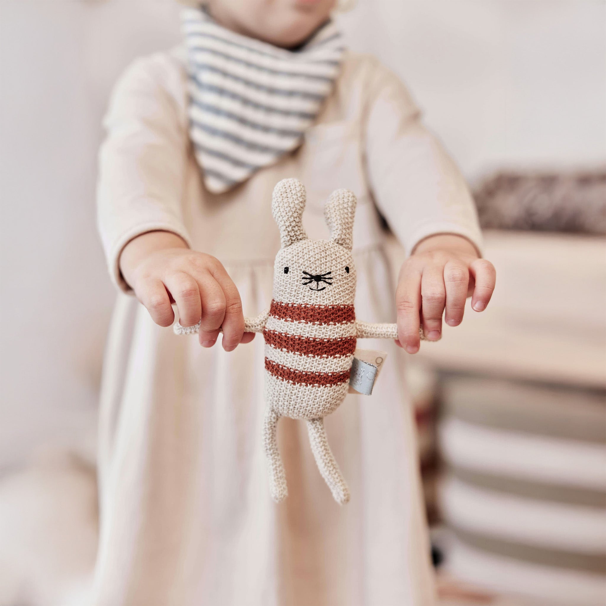 OYOY Musetti Mouse Rattle — Knitted cream-and-rust striped mouse rattle with large ears, cotton body, and recycled filling — eco-friendly baby toy for play and snuggles.