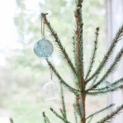 Natale Dots Glass Ball Set by OYOY Living Design — pair of mouth-blown dotted glass ornaments in Clear + Green or Clear + Nutmeg with leather loops.