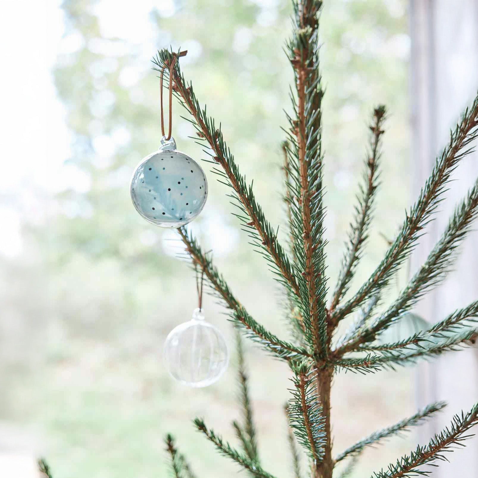 Natale Dots Glass Ball Set by OYOY Living Design — pair of mouth-blown dotted glass ornaments in Clear + Green or Clear + Nutmeg with leather loops.