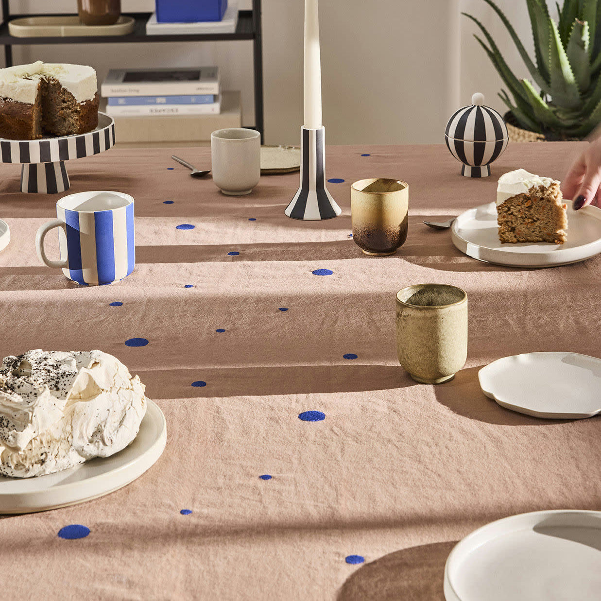 OYOY Nori Tablecloth in terracotta with scattered optic-blue dots, 100% organic cotton, available in two sizes.