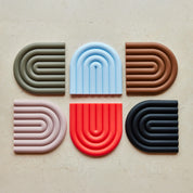 OYOY Living Design Rainbow Trivet in silicone with rainbow arc design. Heat-safe, wipe-clean trivet, designed in Denmark.
