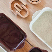 OYOY Living Design Rainbow Wooden Trivet in oak with brass details. Foldable rainbow shape expands for hot pots or hangs as wall décor.